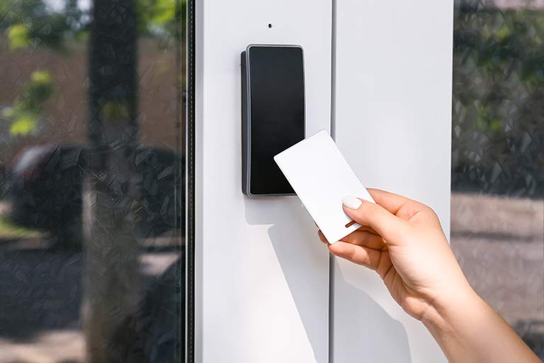 Flush-mounted access control card reader at a glass entry